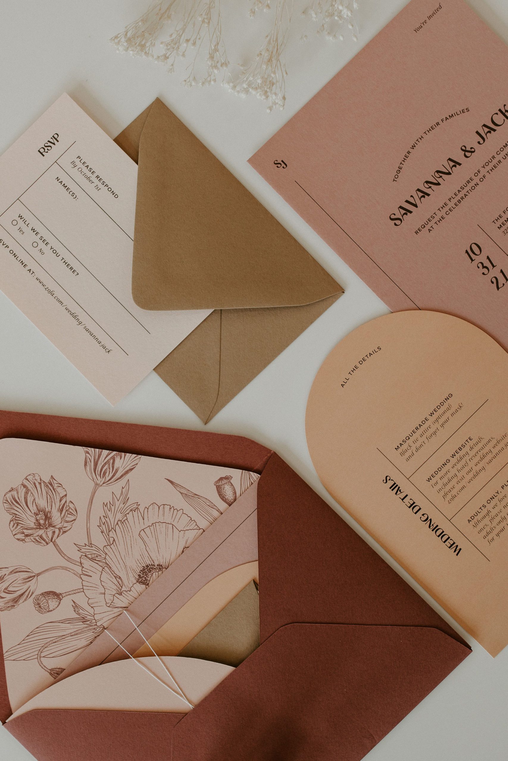 Flat lay view of a wedding invitation suite and all of its pieces on a table.